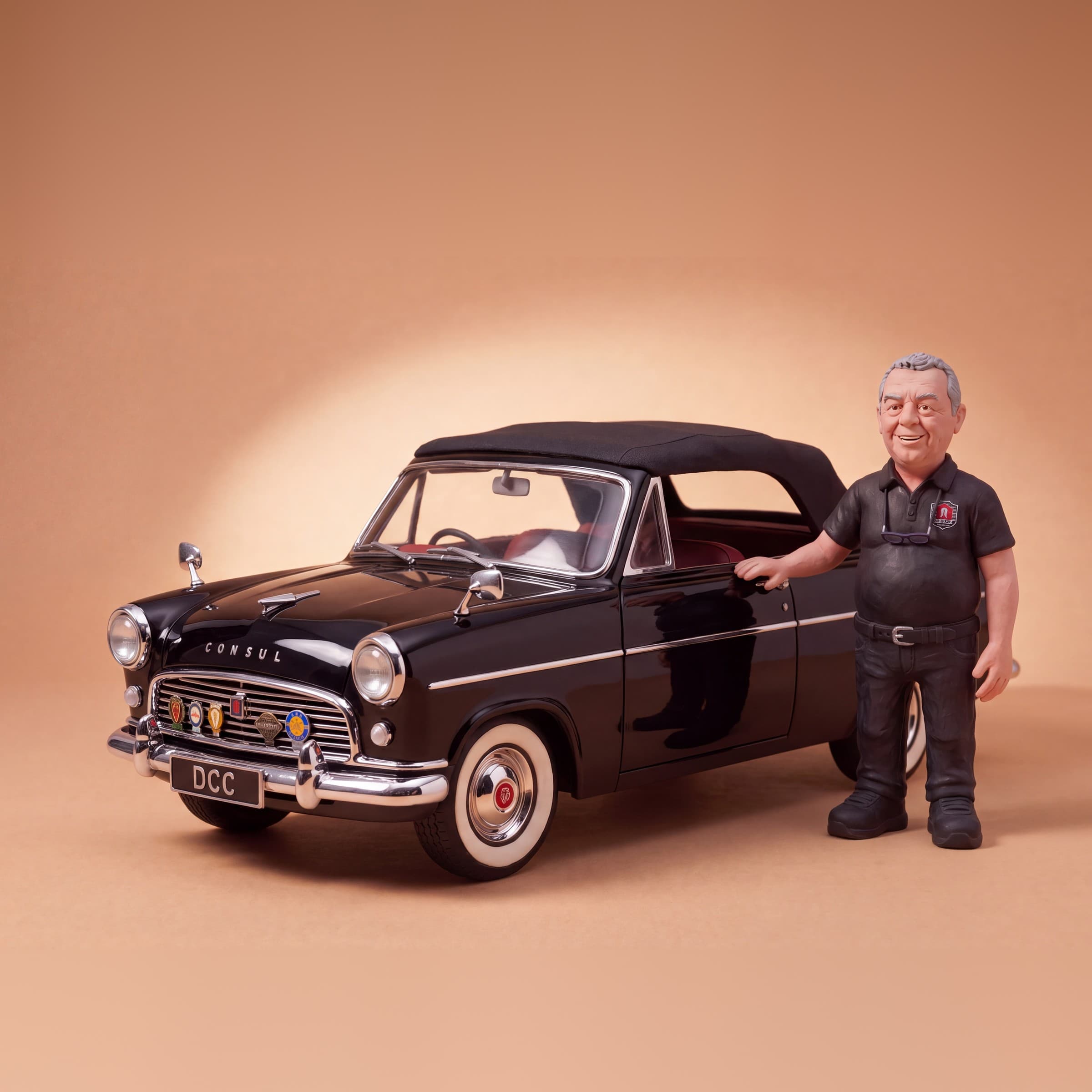 Clay Dean standing beside his gloss black 1955 Ford Consul Mk1 Convertible, hood up, white-wall tyres